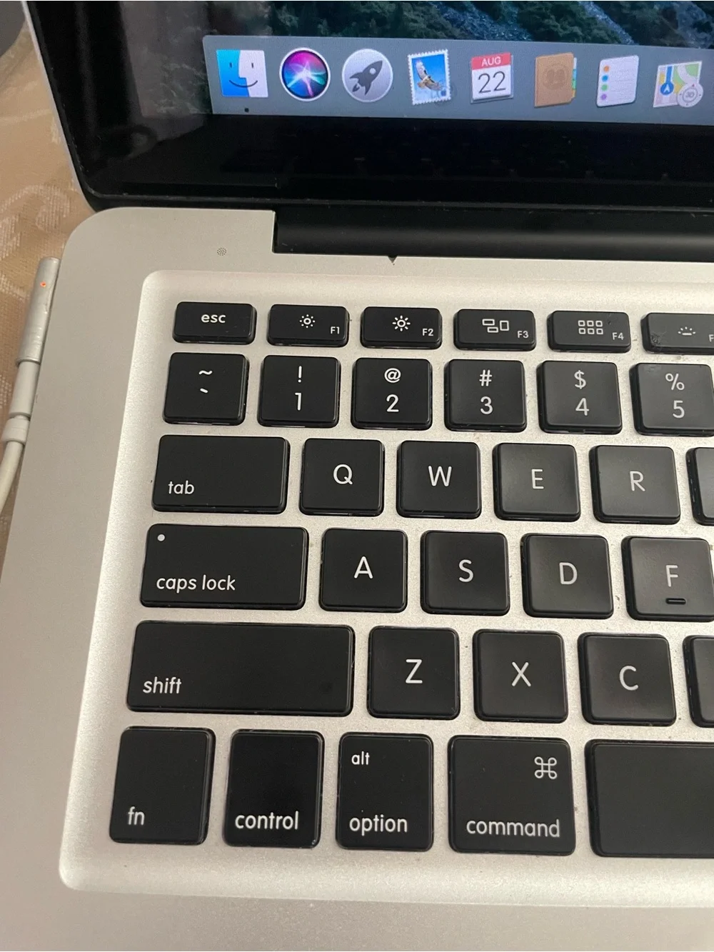 Apple MacBook Pro Silver with Black Keyboard and Sticker